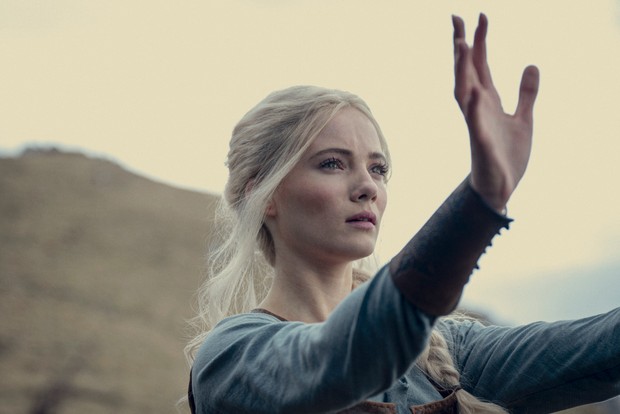 Freya Allan in The Witcher, with her arms outstretched