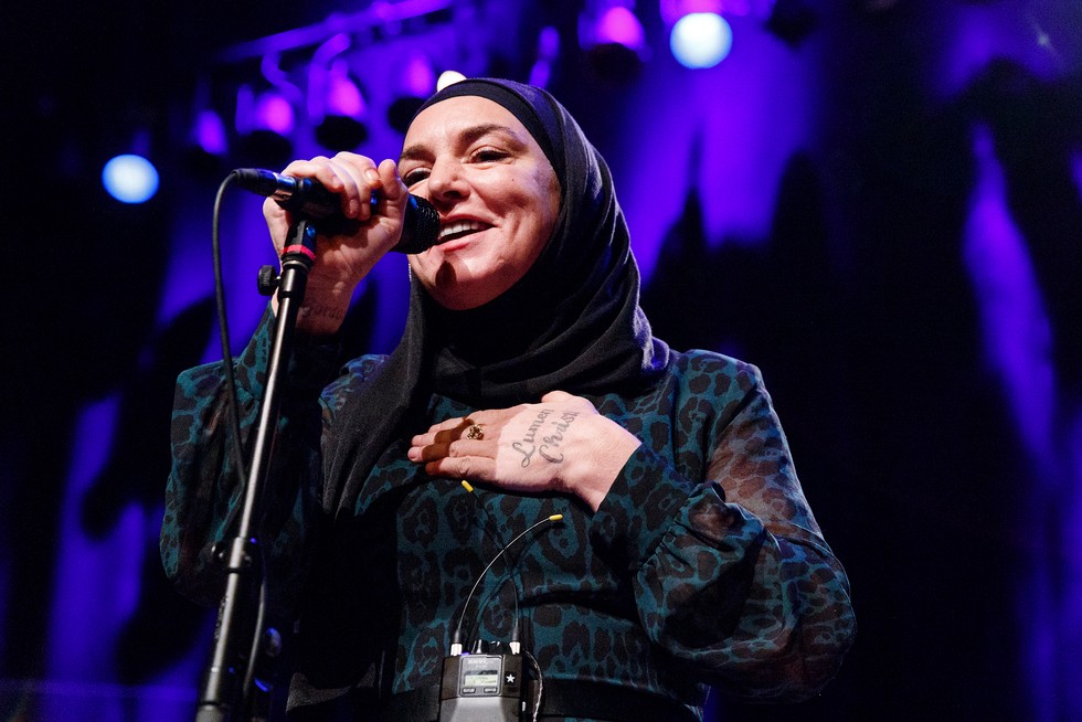 Sinéad O'Connor wearing a black headscarf and dress
