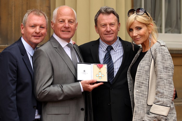 Co-founder of gay and lesbian campaign group Stonewall, former television actor and Labour politician, Michael Cashman (2L), poses with partner Paul Cottingham (L), brother John Cashman (2R) and friend Michelle Collins (R) after he received his appointment as a Commander of the Order of the British Empire (CBE) for public and political service from Britain's Prince Charles, Prince of Wales, during an investiture ceremony at Buckingham Palace in central London on May 10, 2013.