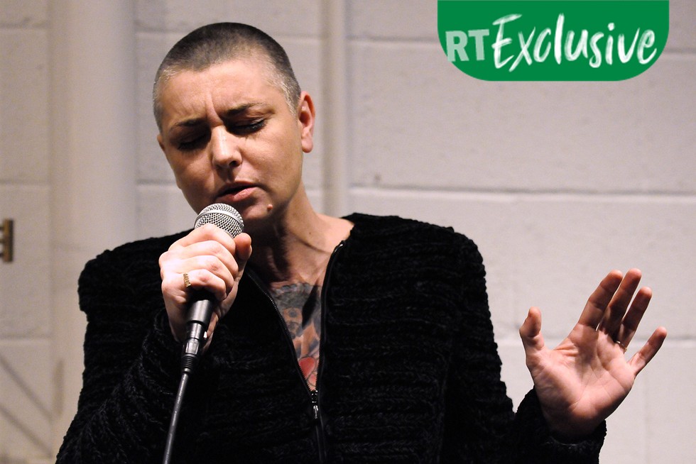Sinéad O'Connor singing into a microphone with an RT Exclusive picture label
