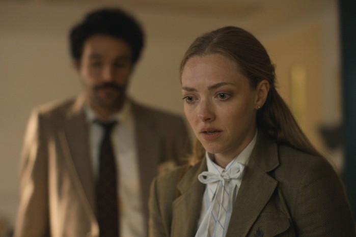 Amanda Seyfried wearing a suit, with Christopher Abbott in the background