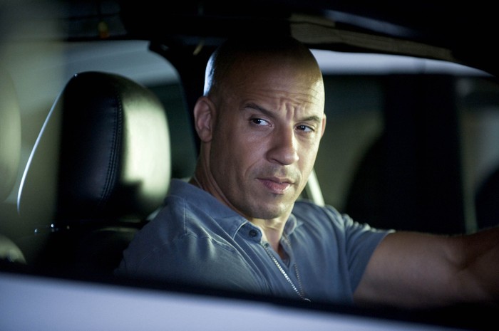 VIN DIESEL in Fast Five, sitting in a car and looking out of the window